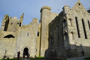 Stone medieval castle ruins with towers under blue sky