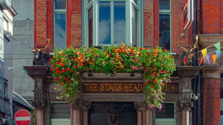 Victorian pub facade with ornate columns and flower boxes