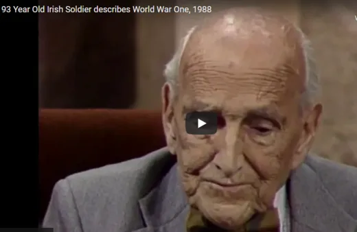 Elderly man in suit speaking during filmed interview, circa 1988