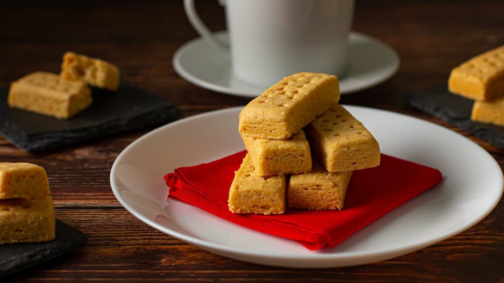 Shortbread fingers on a plate with a cup of tea