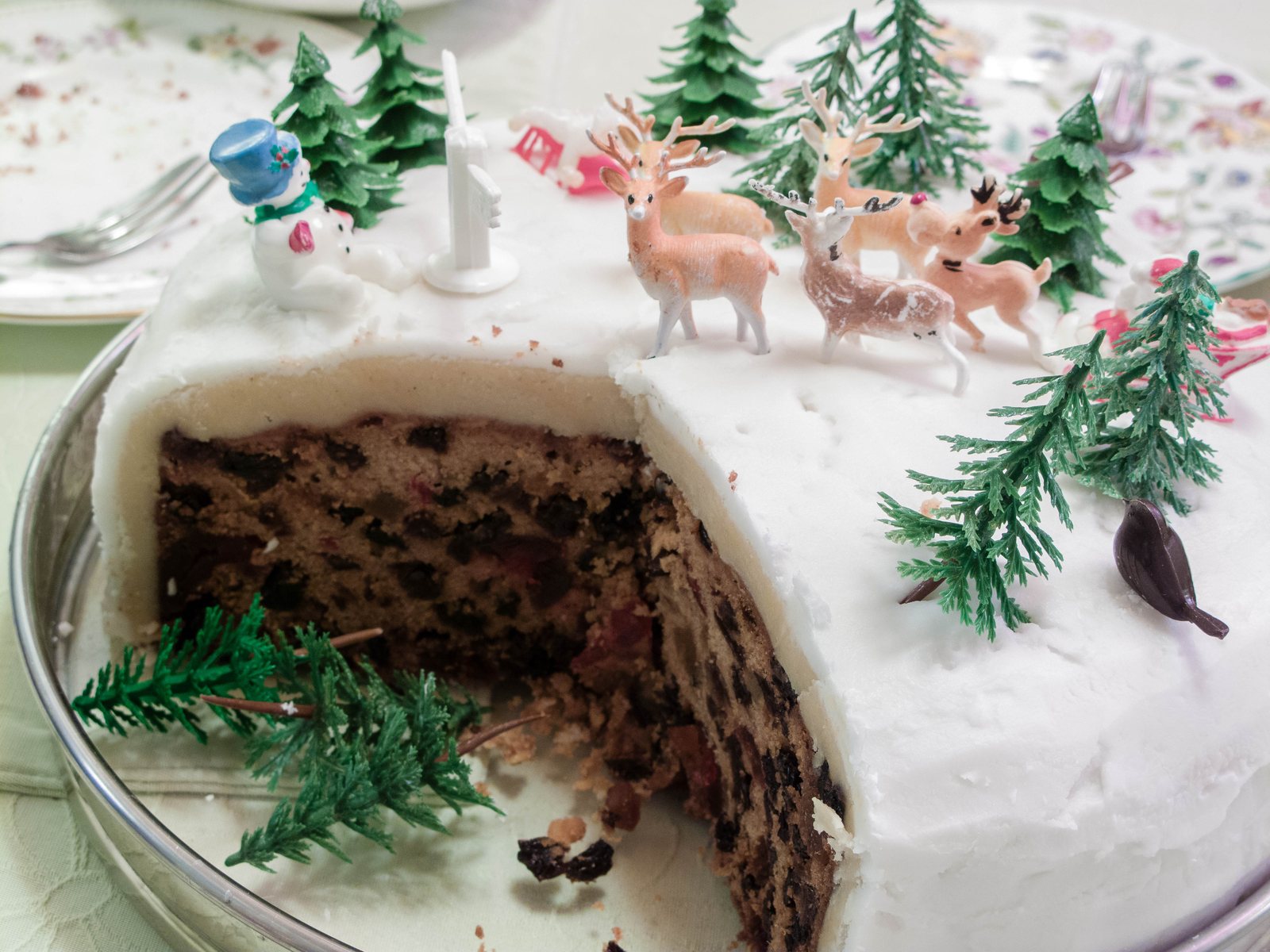 A Christmas cake covered in marzipan and white icing
