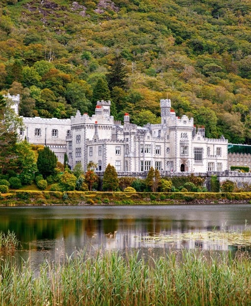 Kylemore Abbey reflecting on still water during a 4 day Ireland itinerary