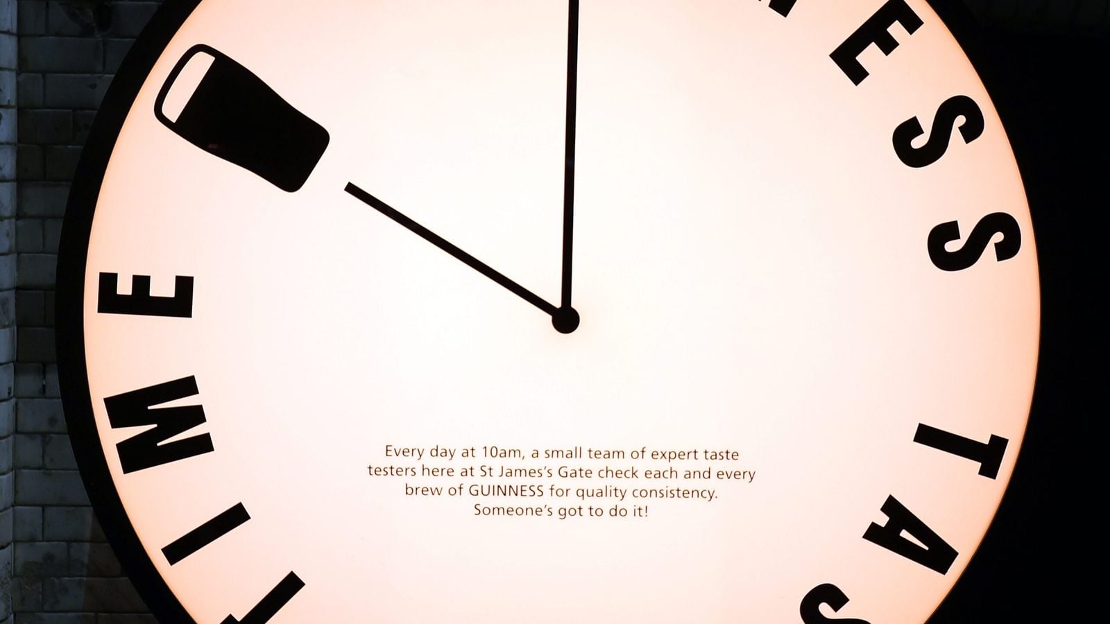 Pints of Guinness in a Dublin pub displaying the iconic Irish harp logo