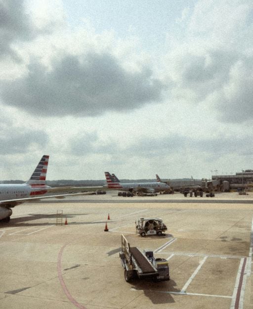 Aeroplanes at airport gates under cloudy skies, ready for flights to Ireland
