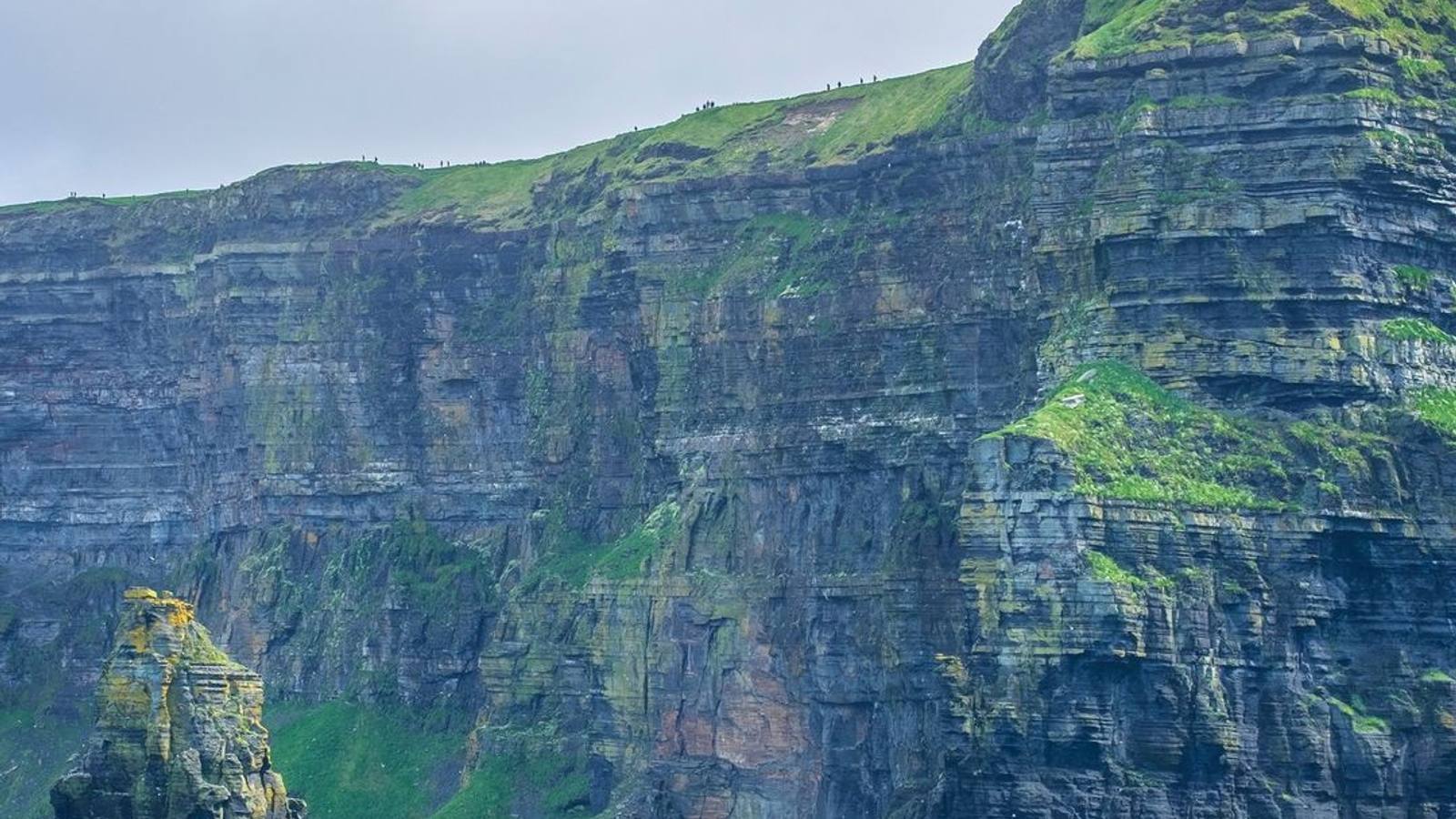 Dramatic view of the Cliffs of Moher from the sea, dark Atlantic waves below, County Clare Ireland