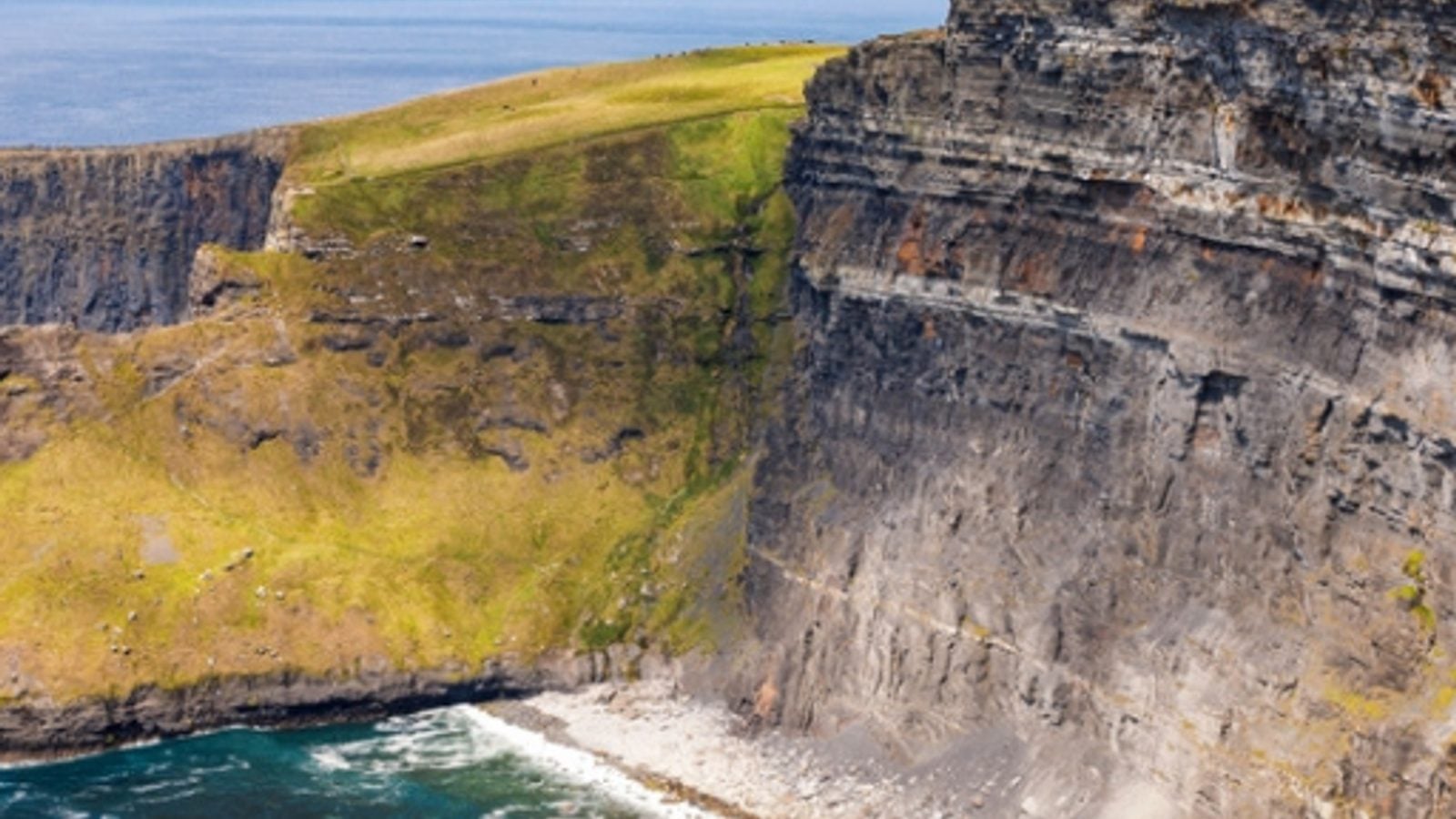 The Cliffs of Moher rising dramatically above the Atlantic Ocean in County Clare, Ireland