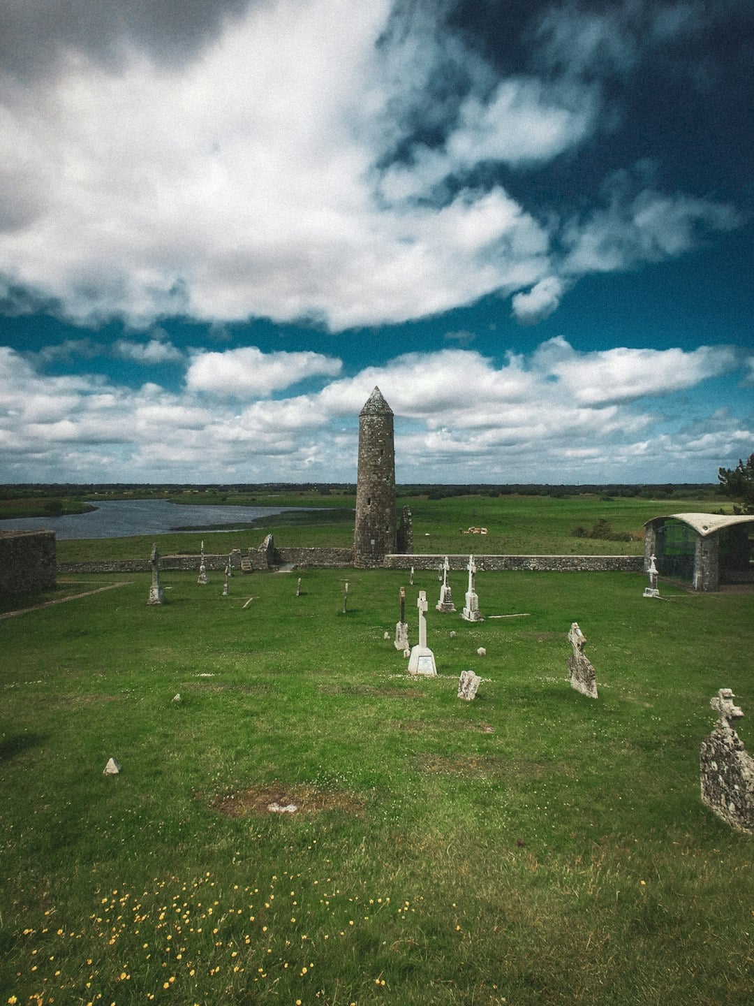 Clonmacnoise round tower and ancient gravestones, County Offaly, Ireland