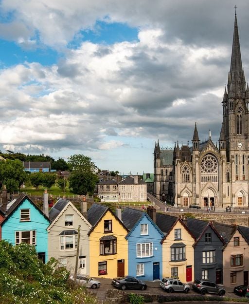 Colourful houses and St Colman's Cathedral overlooking Cork Harbour in Cobh — Ireland's historic emigration port, the last place millions of Irish people saw before leaving for America