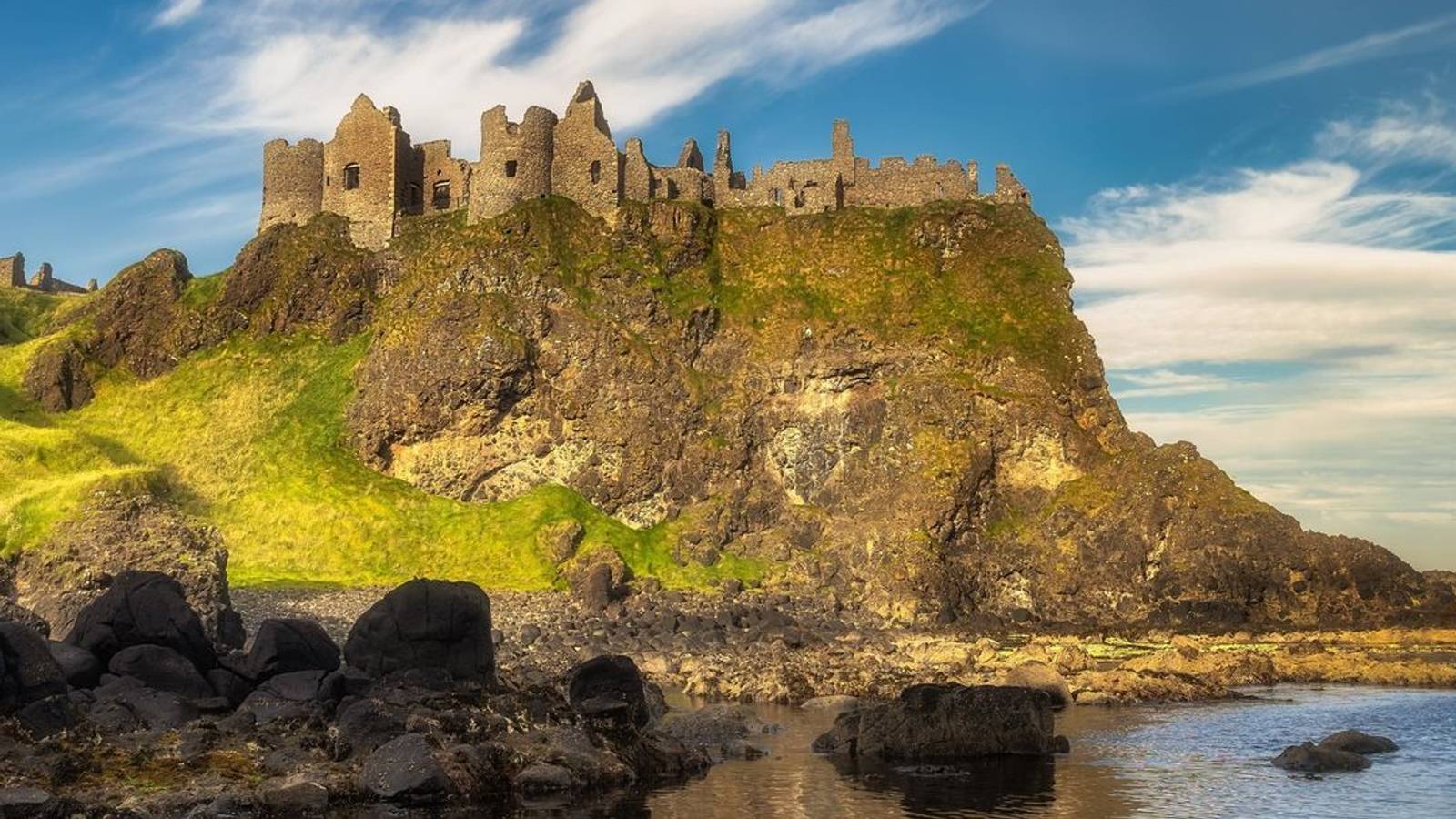 Ruins of Dunluce Castle perched on sea cliffs in Northern Ireland