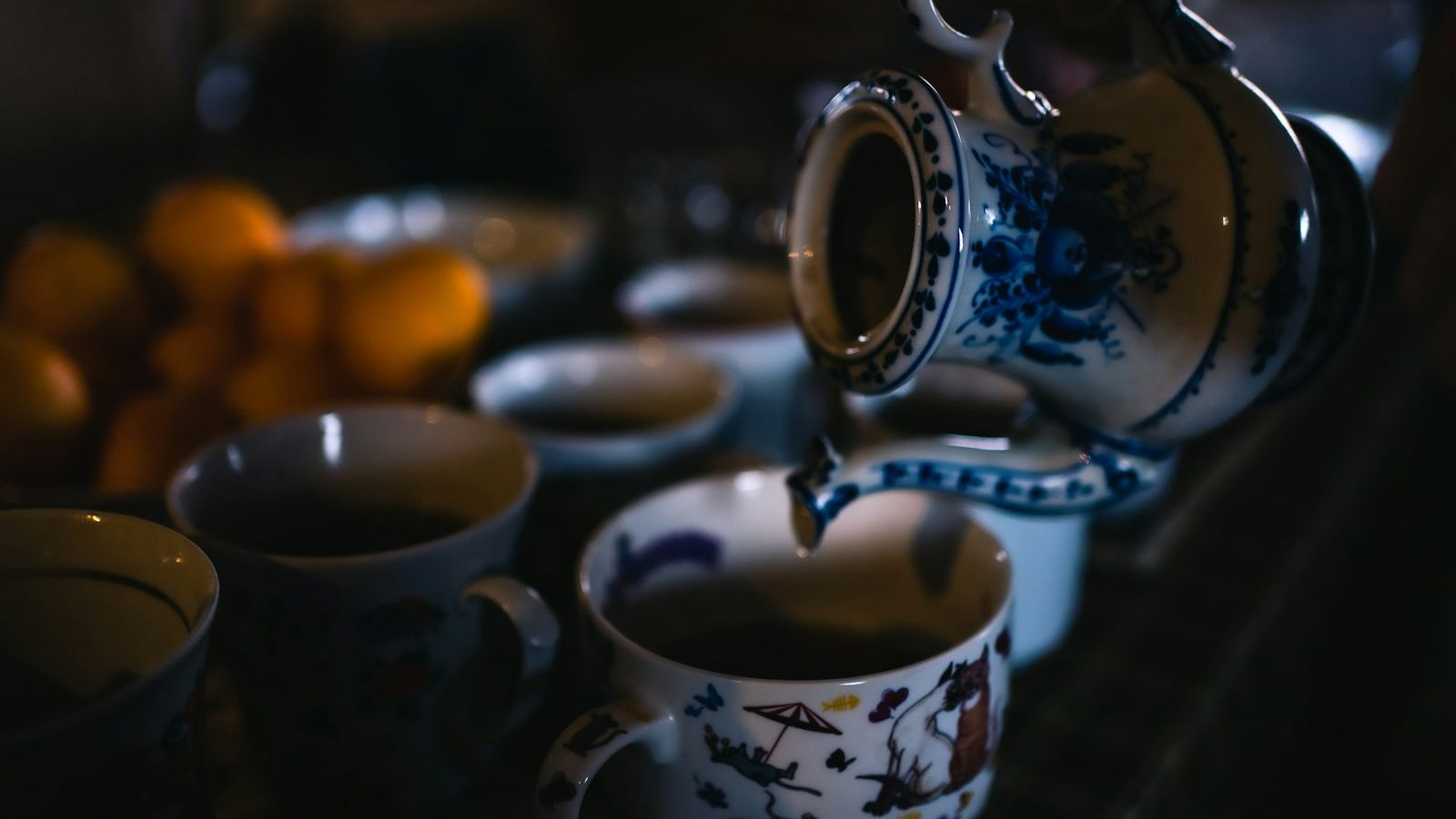 Pouring a pot of tea into a china cup, the centrepiece of Irish hospitality