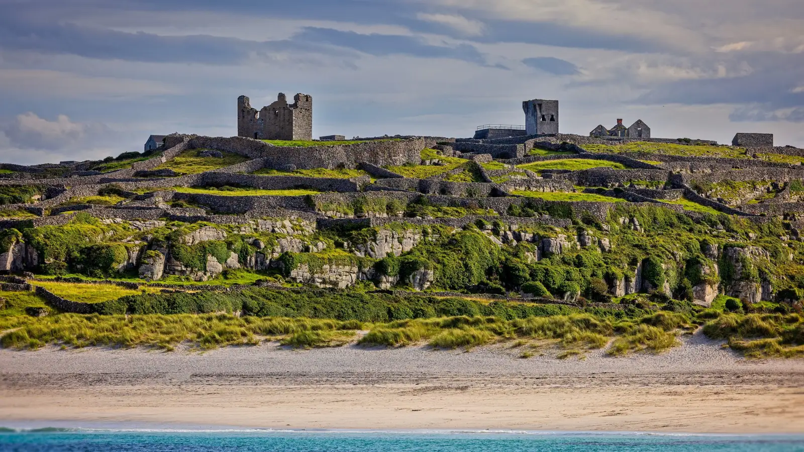 Traditional stone cottages and village on the Aran Islands with the Atlantic coastline in the background