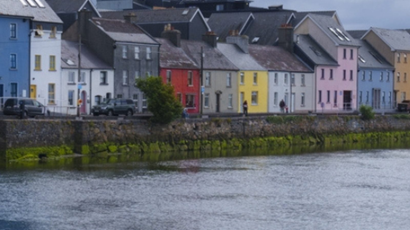 Colourful painted buildings and shopfronts along the waterfront in Galway, Ireland