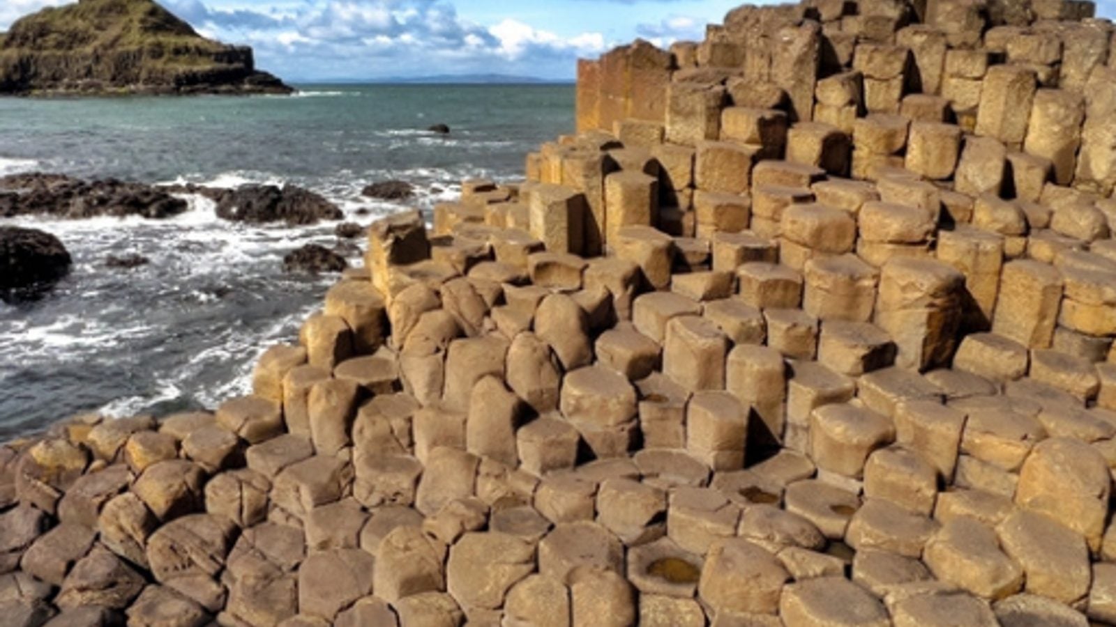 The Giant's Causeway hexagonal basalt columns stretching into the Atlantic Ocean, County Antrim, Northern Ireland