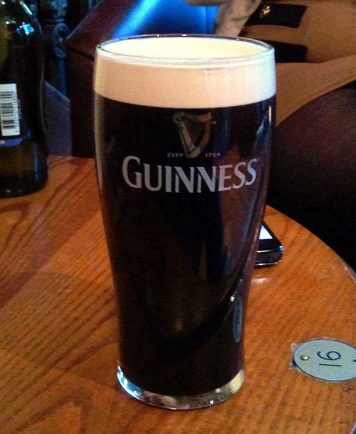 A pint of Guinness showing the iconic harp logo on the glass