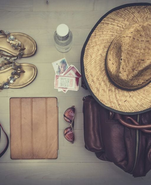 Travel essentials and clothing laid out for packing an Ireland trip