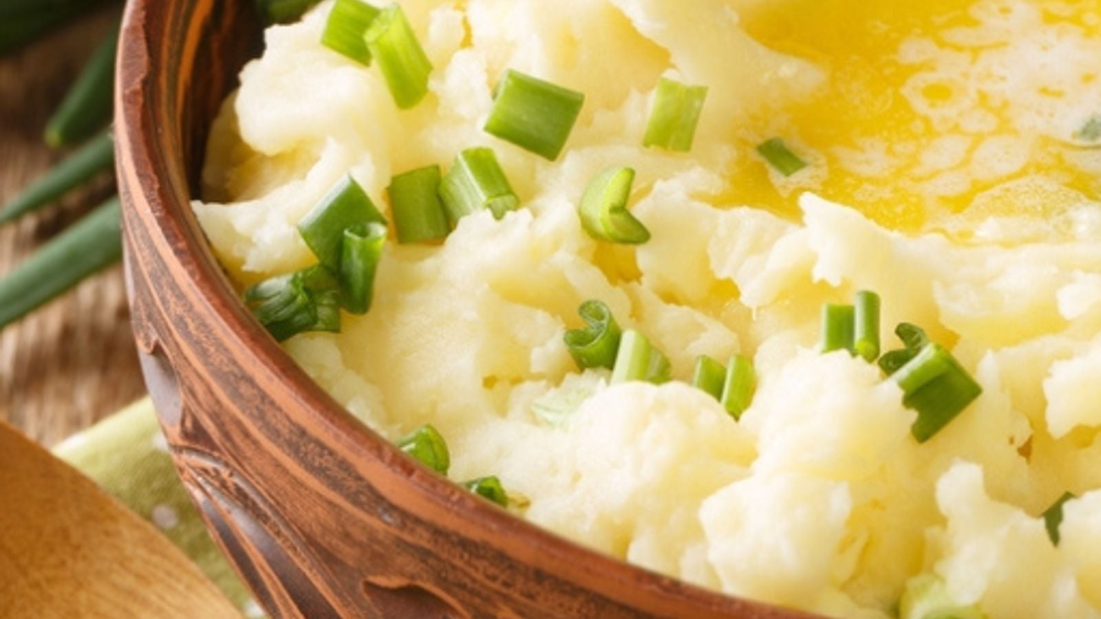 Bowl of creamy Irish colcannon mashed potato with melted butter and spring onions, a traditional Irish dish