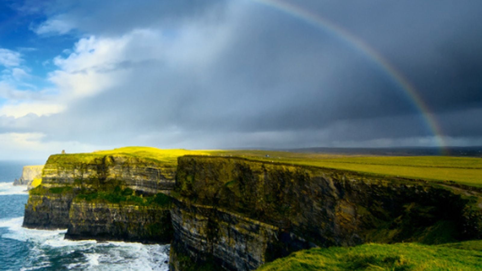 Rainbow arching over the dramatic Cliffs of Moher on Ireland's wild Atlantic coast