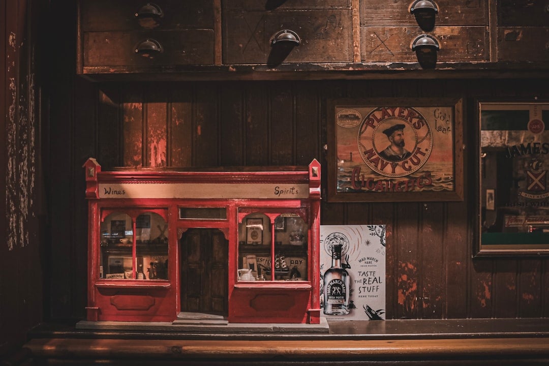 a red store front with a bottle of whiskey on the counter