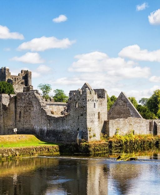 Desmond Castle ruins reflected in the River Maigue at Adare, County Limerick &ndash; seat of the Earls of Desmond and ancestral heartland of the FitzGerald surname