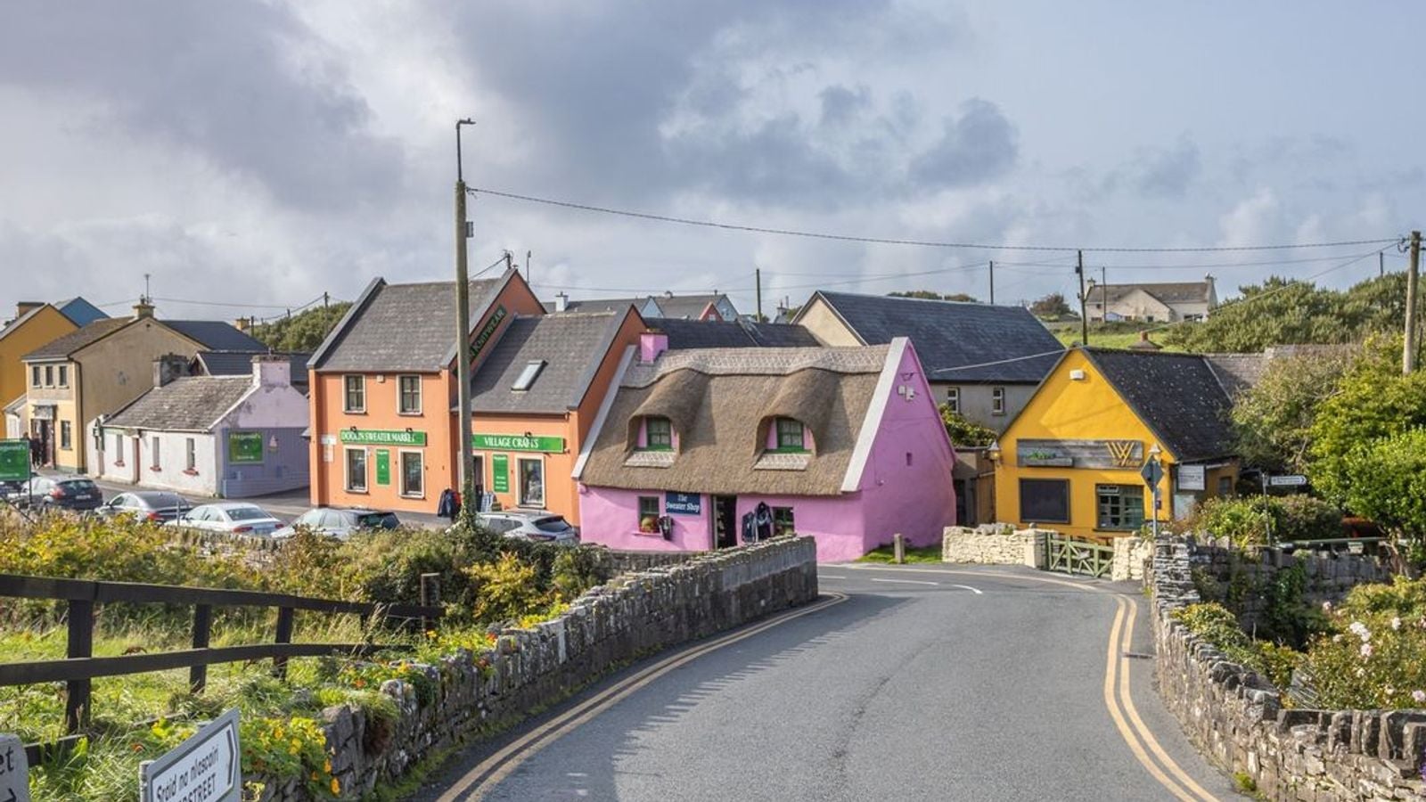 The colourful village of Doolin in County Clare, Ireland, with its traditional cottages and rolling green hills