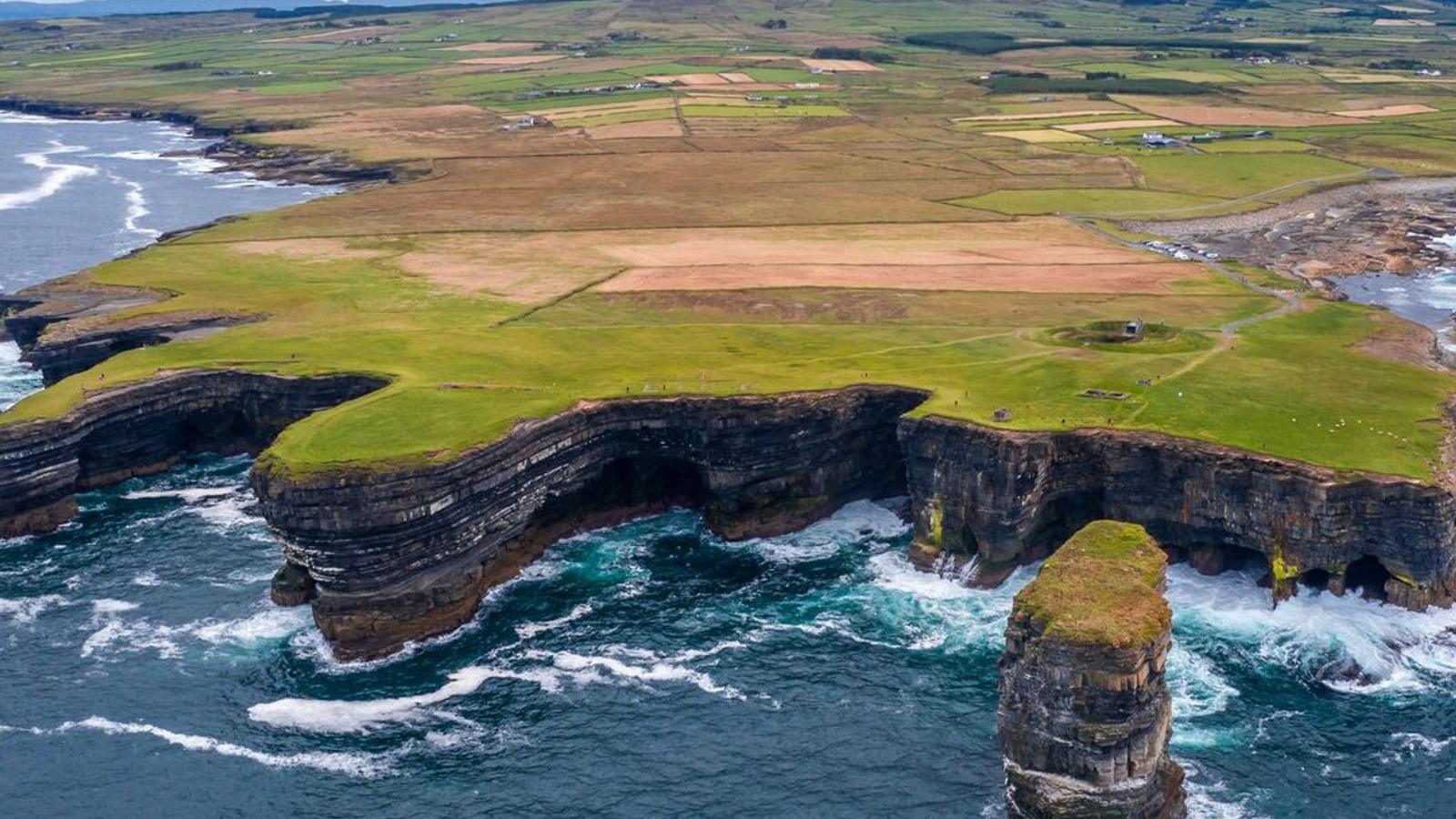 Aerial view of Downpatrick Head in County Mayo, showing Ireland's patchwork of green fields divided by ancient boundaries