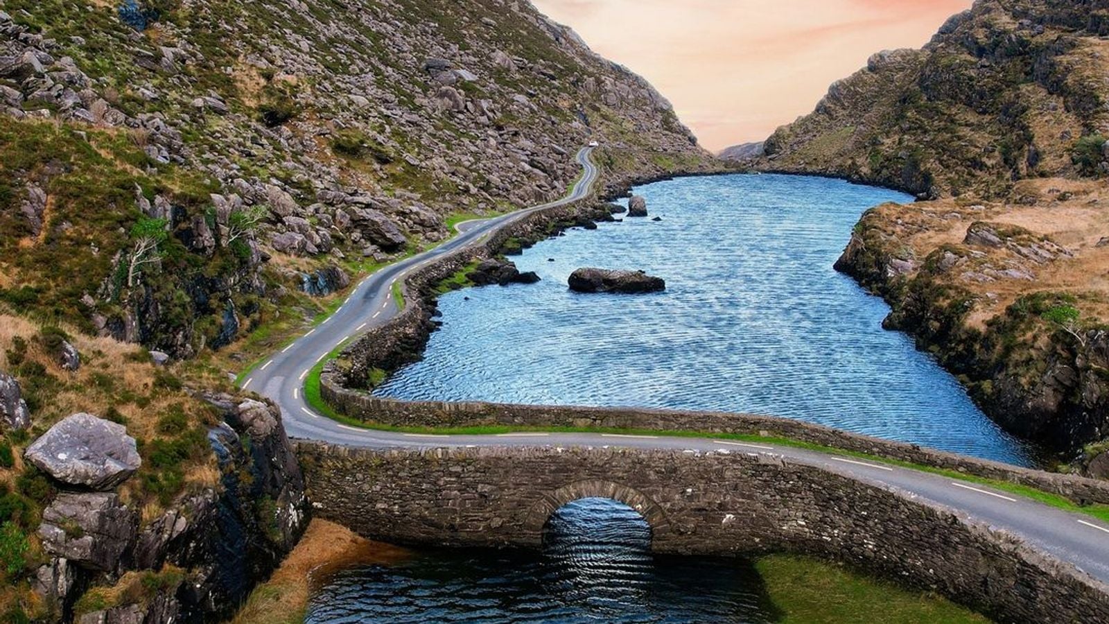 Aerial view of the Gap of Dunloe in County Kerry, Ireland, showing ancient stone bridge and mountain landscape