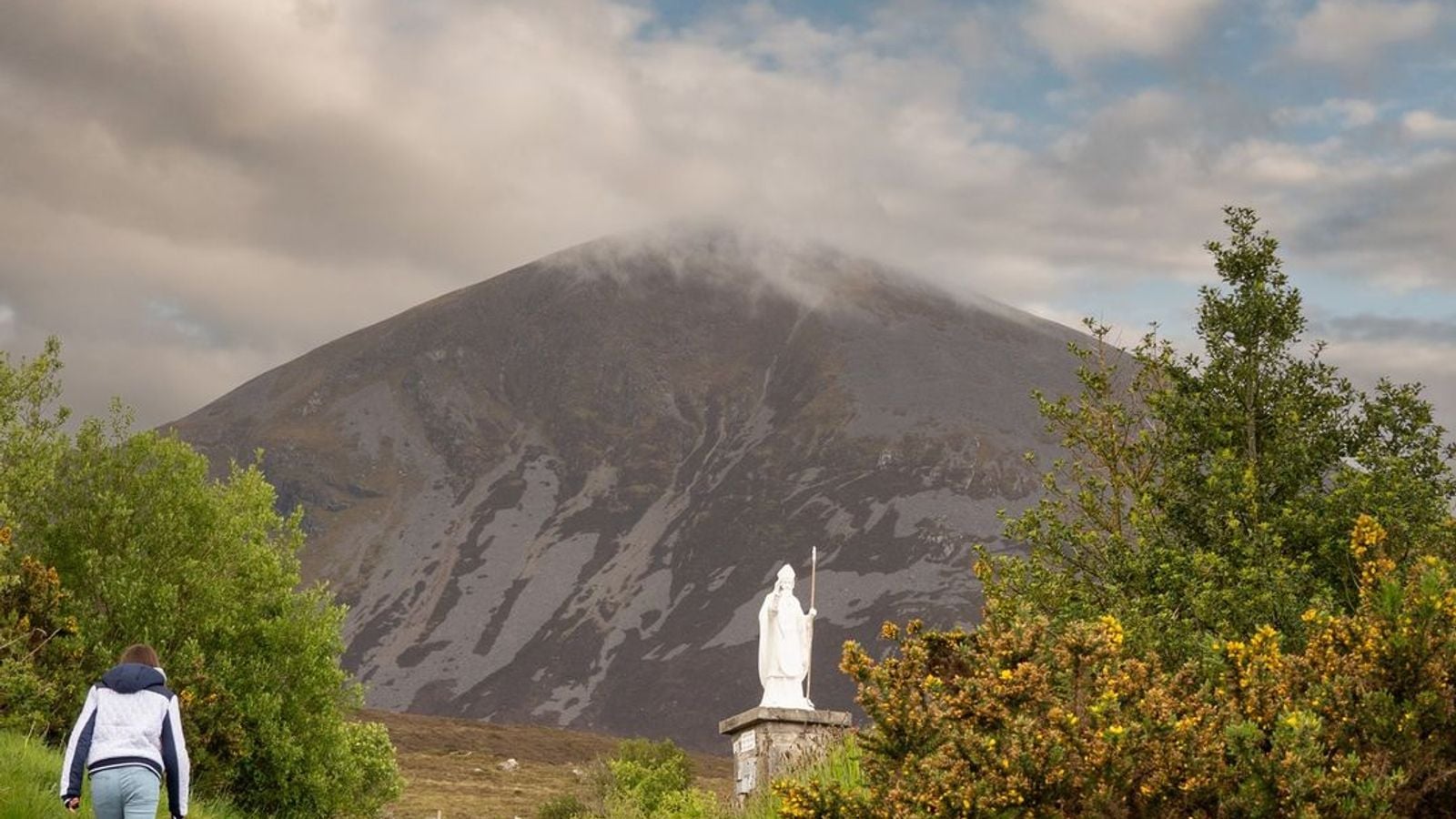 Pilgrims climbing the rocky path up Croagh Patrick in County Mayo, Ireland's sacred pilgrimage mountain