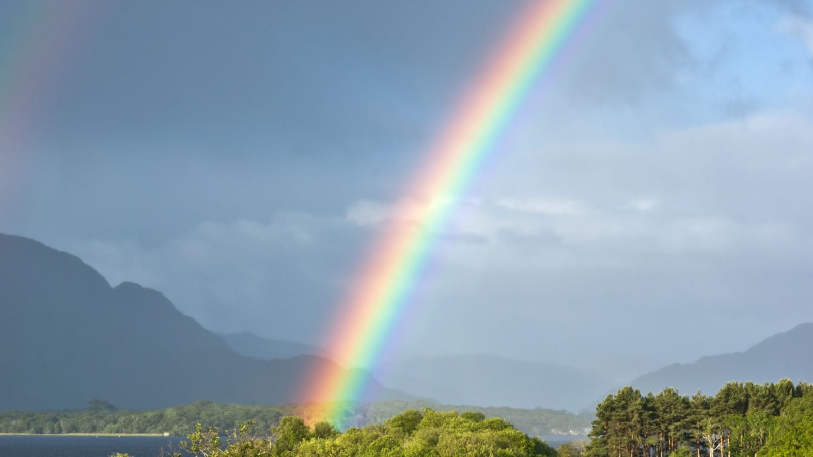 Double rainbow reflected over Lough Leane lake in Killarney, County Kerry, Ireland