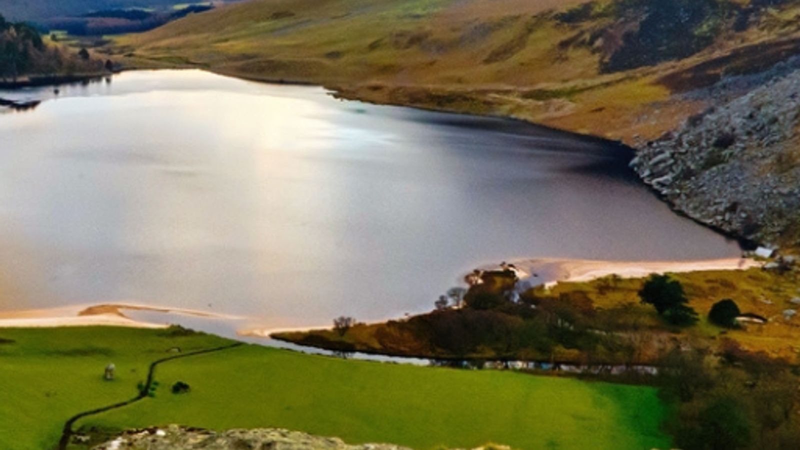 Lough Tay lake in the Wicklow Mountains near Dublin, Ireland, with dramatic cloudy skies