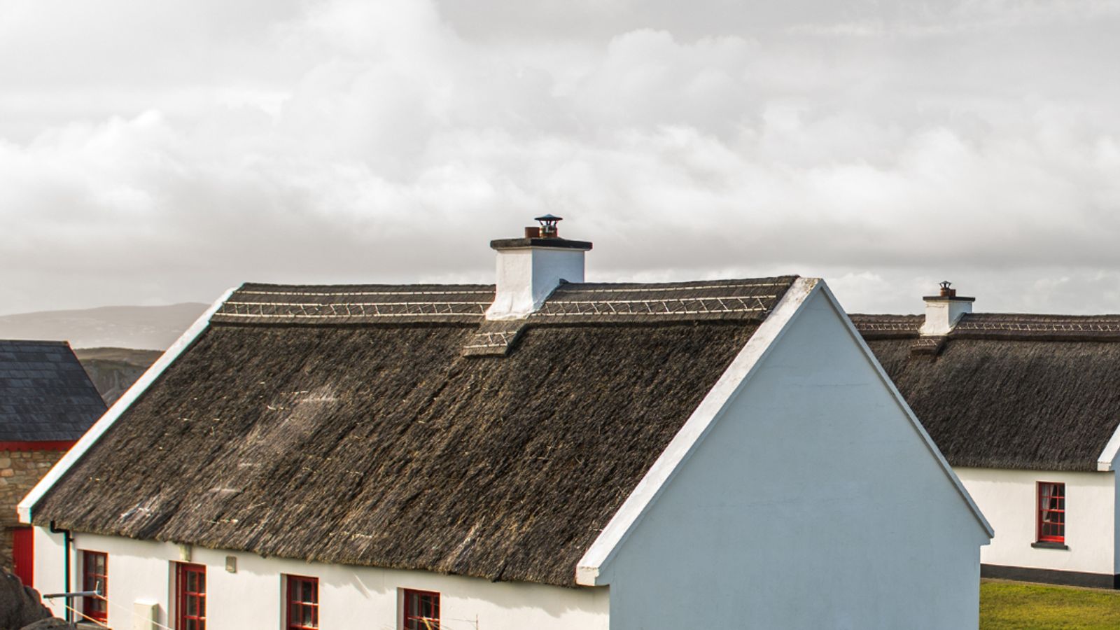 Traditional white-washed thatched cottages on Cruit Island in County Donegal, Ireland
