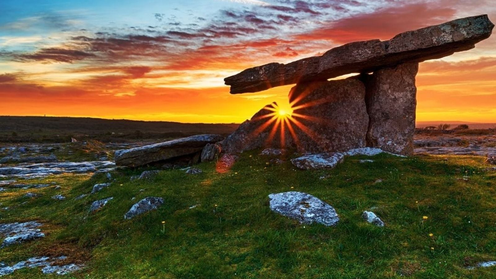 Poulnabrone portal tomb dolmen at dramatic sunset in the Burren limestone landscape County Clare Ireland