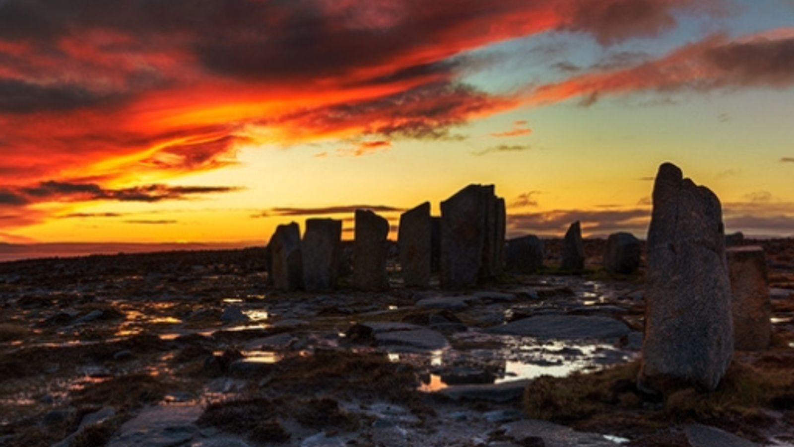 Dramatic sunrise over ancient standing stones on a peat bog at Falmore Wild Atlantic Way County Mayo Ireland