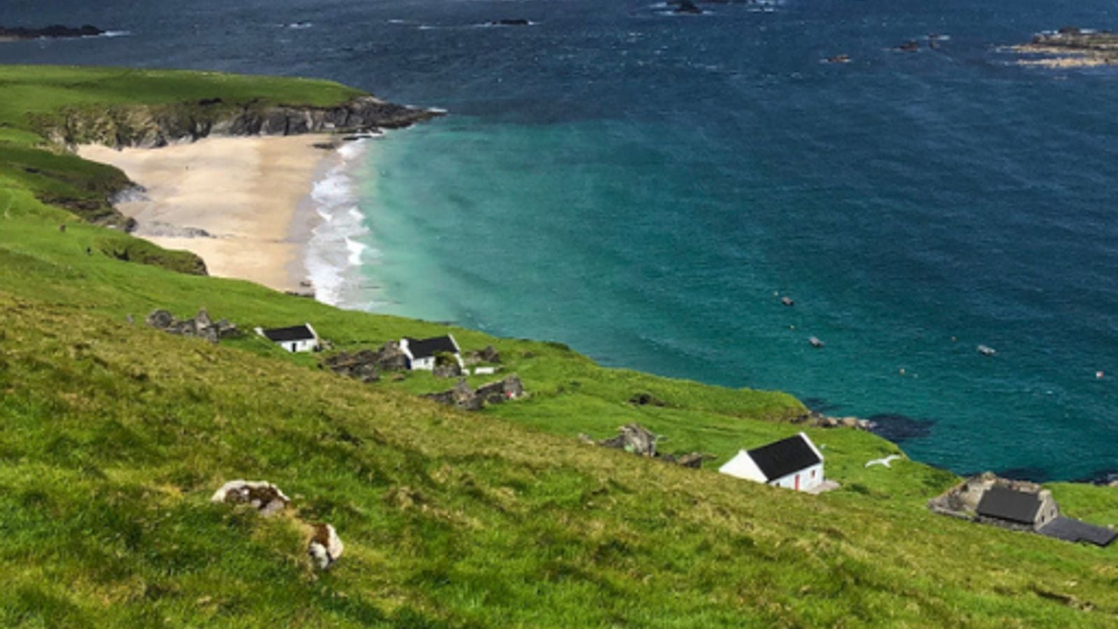 Ruined stone houses and green hillsides on the Great Blasket Island off the Dingle Peninsula in County Kerry