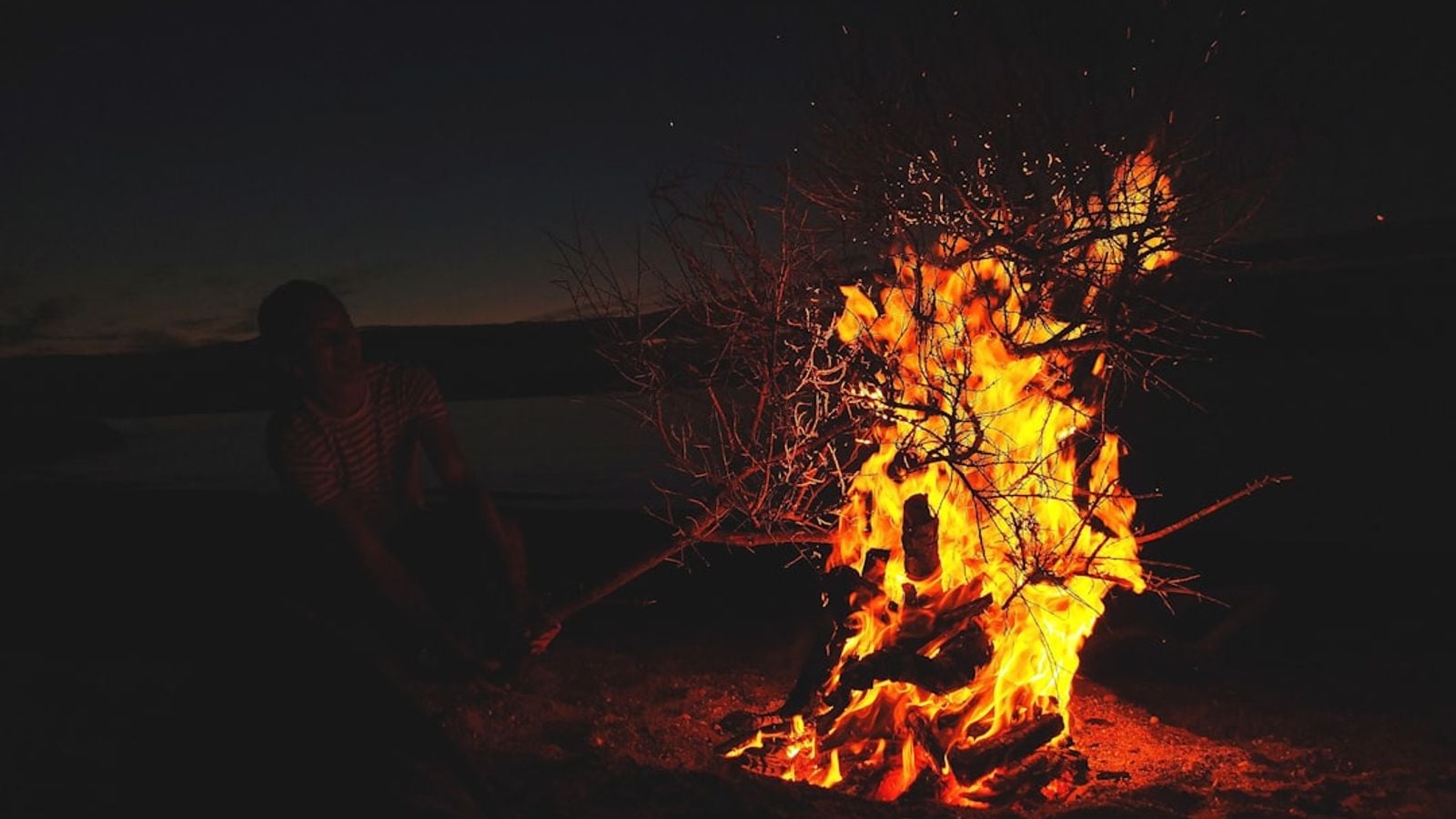 A blazing bonfire on an Irish beach at sunrise, celebrating the ancient tradition of Bealtaine