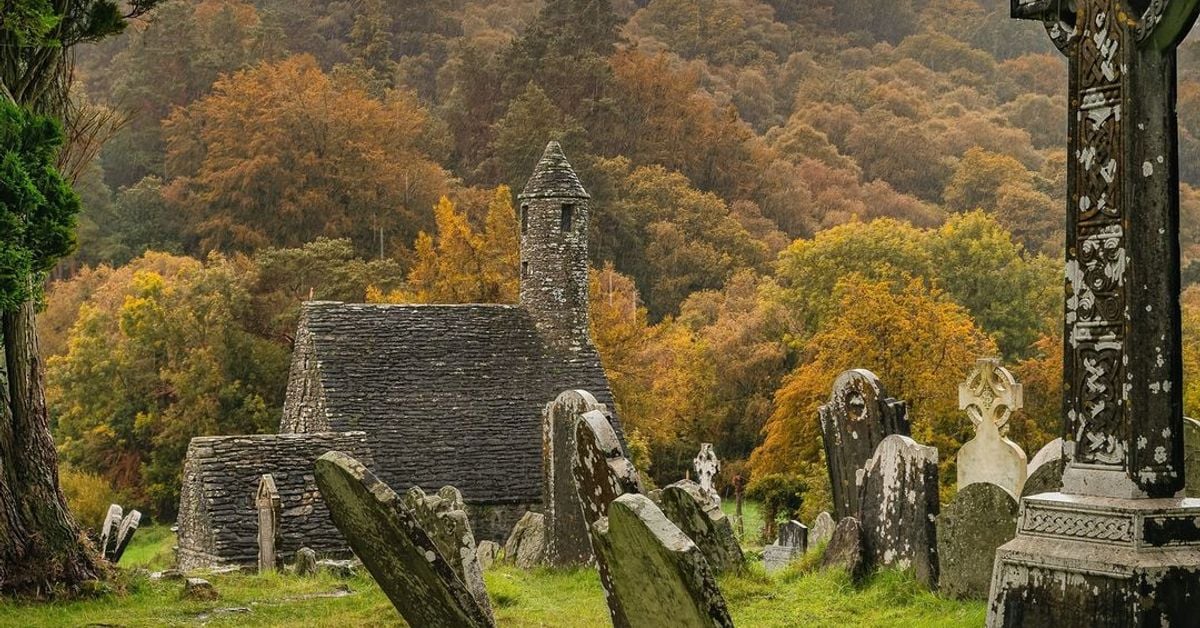 Glendalough ancient monastic site with Celtic cross, County Wicklow, Ireland