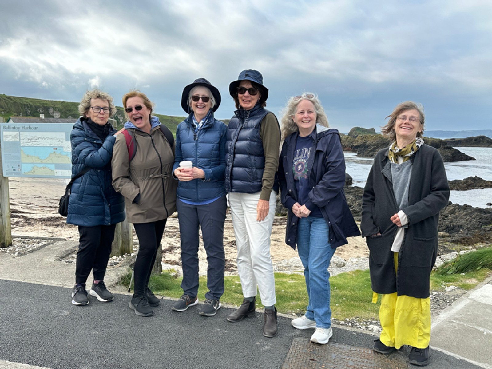 Six women travelers on the Causeway Coast at Ballintoy Harbour, Northern Ireland &mdash; a Kindred Women Travelers group.