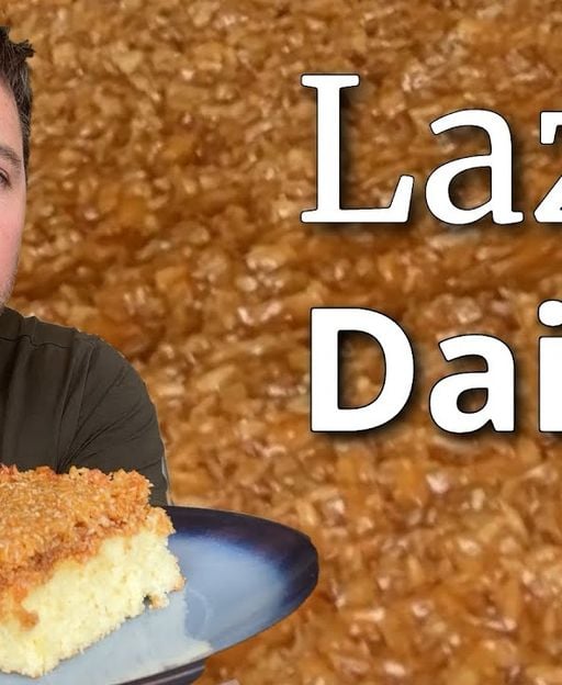 Golden Lazy Daisy Cake (Dr&oslash;mmekage) with caramelised coconut topping, slice showing moist sponge base