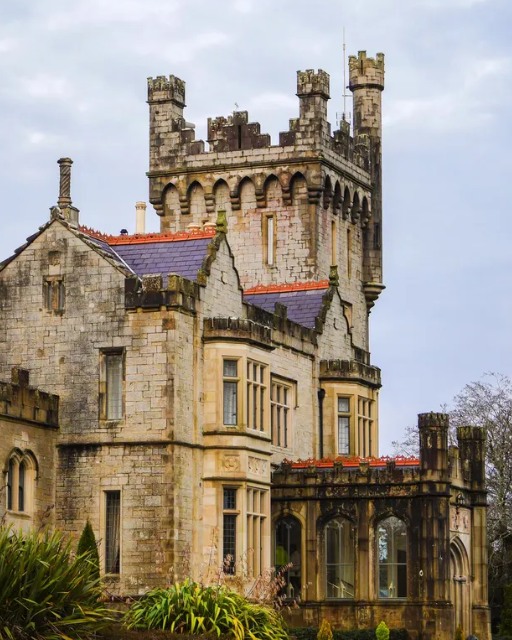 Lough Eske Castle Hotel, County Donegal &mdash; ivy-covered stone castle with crenellated tower on the shores of Lough Eske