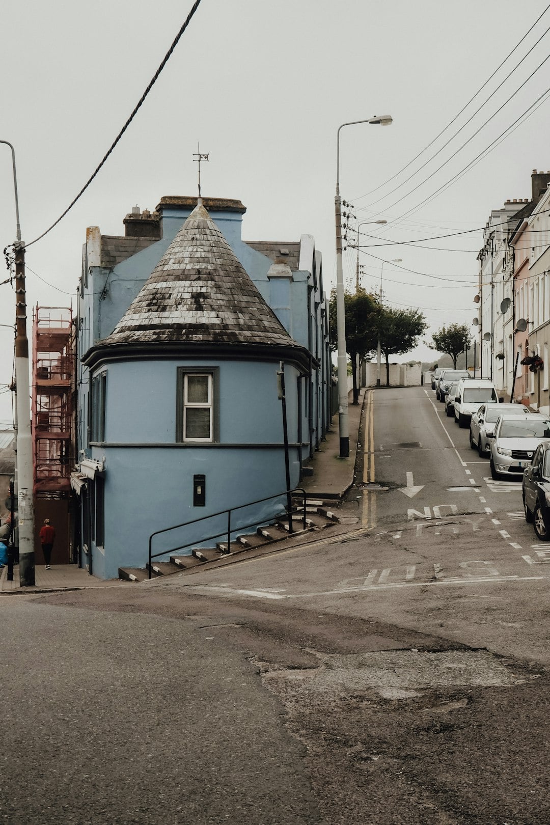 Blue cylindrical building with conical roof on Irish street corner