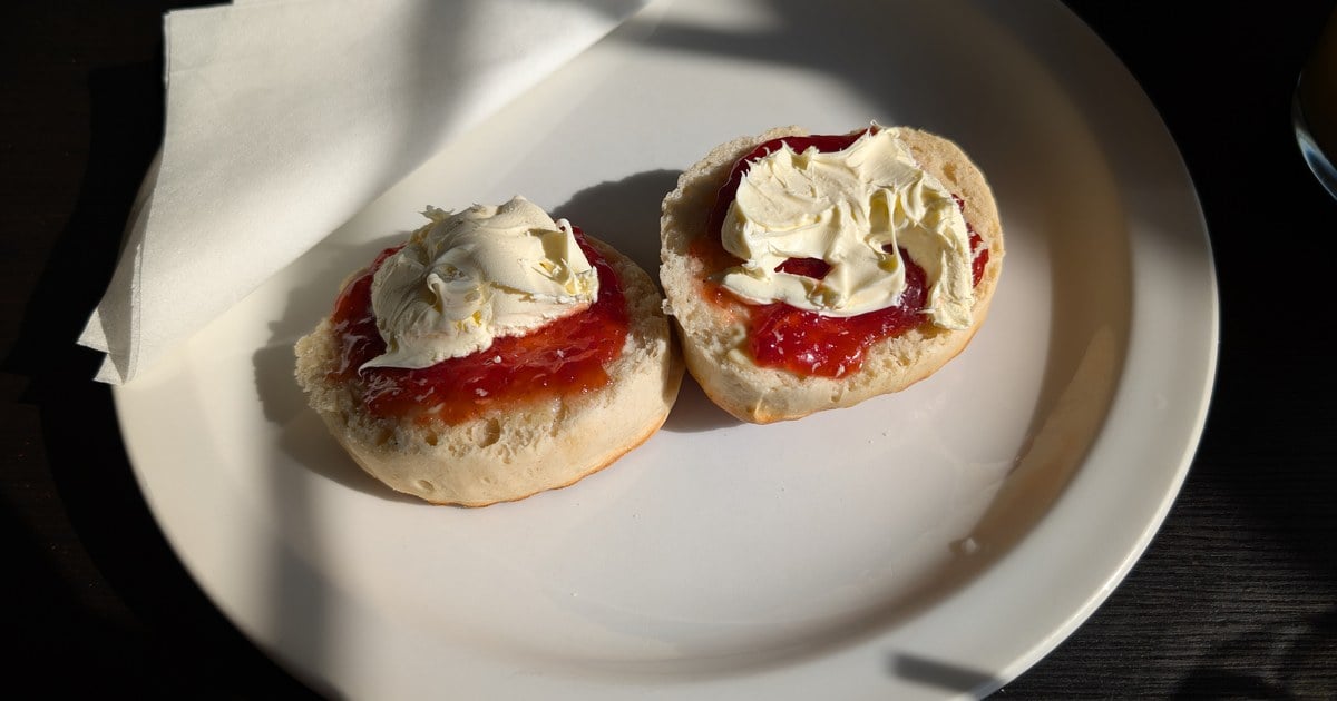 Traditional Irish scones split open with jam and clotted cream