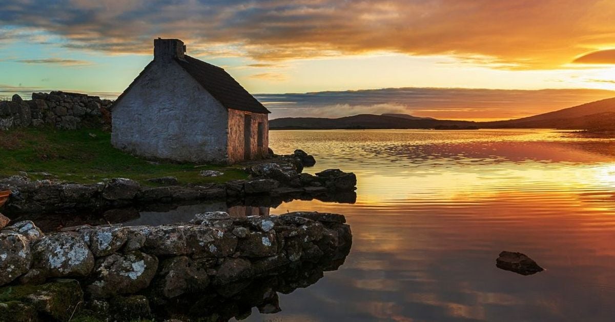 Stone cottage at sunset on the shores of Connemara, County Galway, Ireland