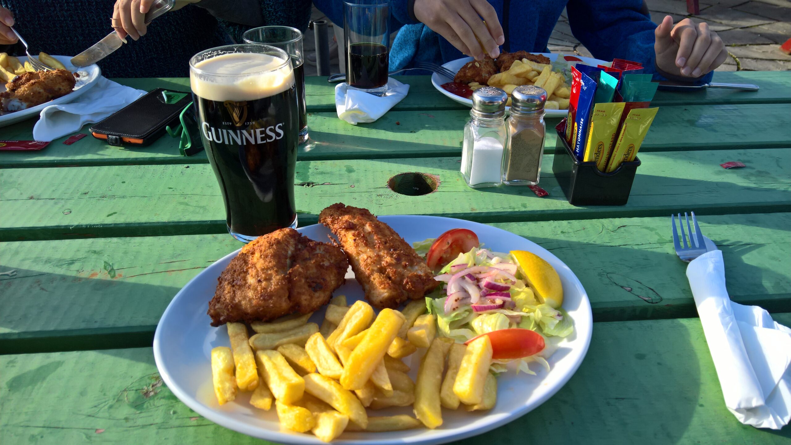 Traditional Irish fish and chips with a pint of Guinness at a pub