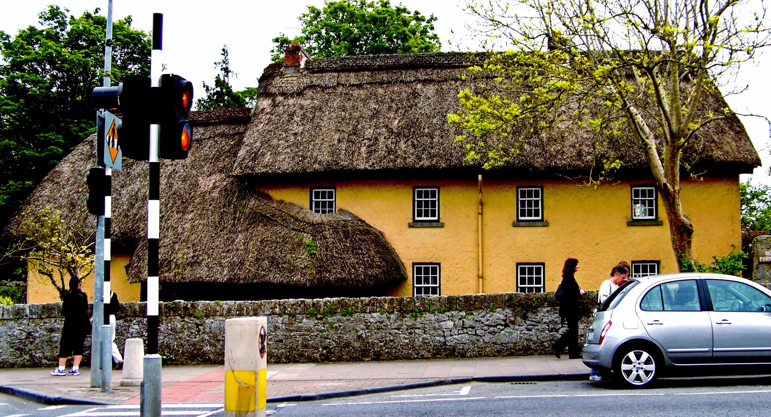 Yellow thatched-roof cottage on Main Street in Adare, Co. Limerick, Ireland