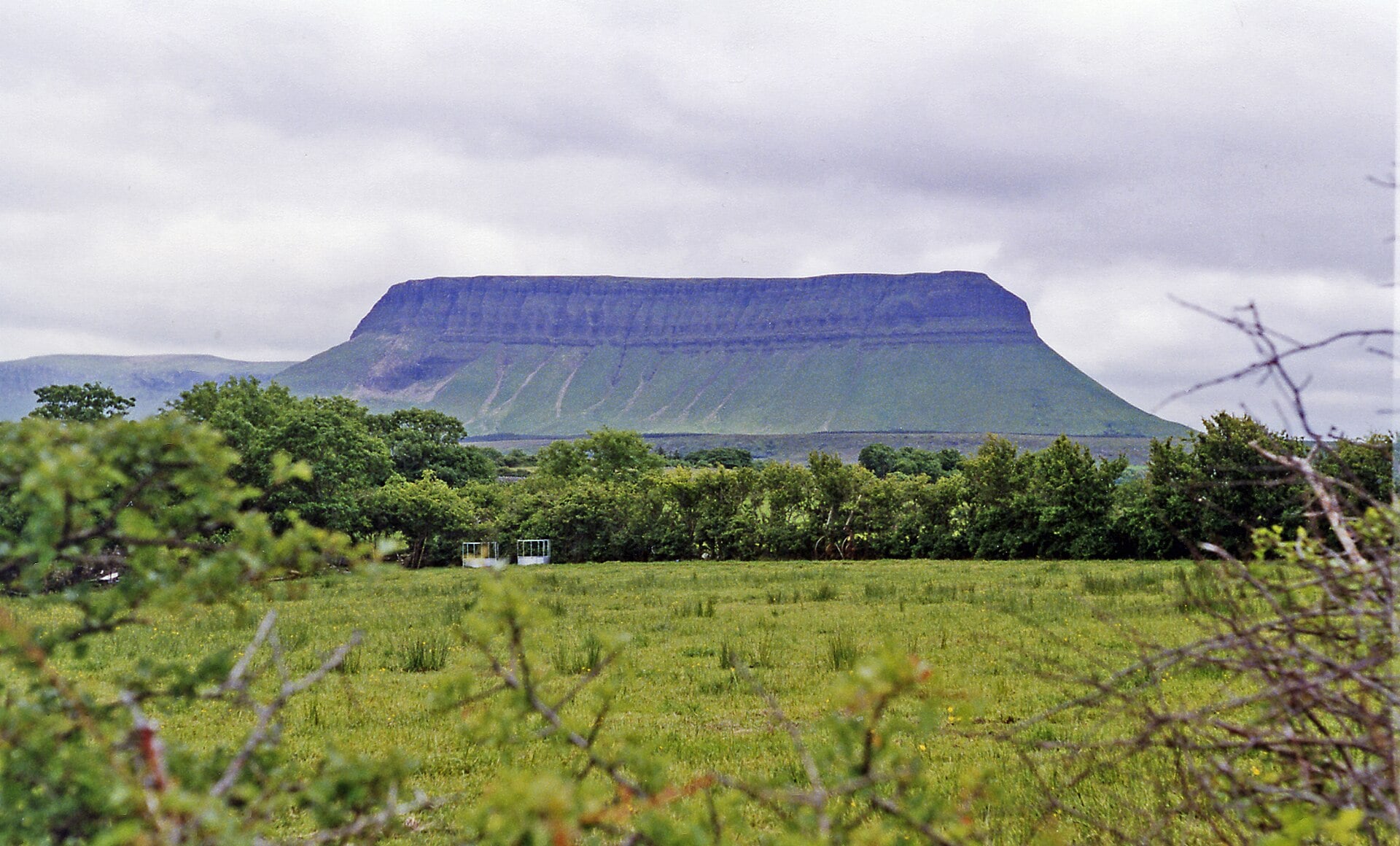 Benbulben's flat-topped profile rising above green farmland near Grange, County Sligo, Ireland