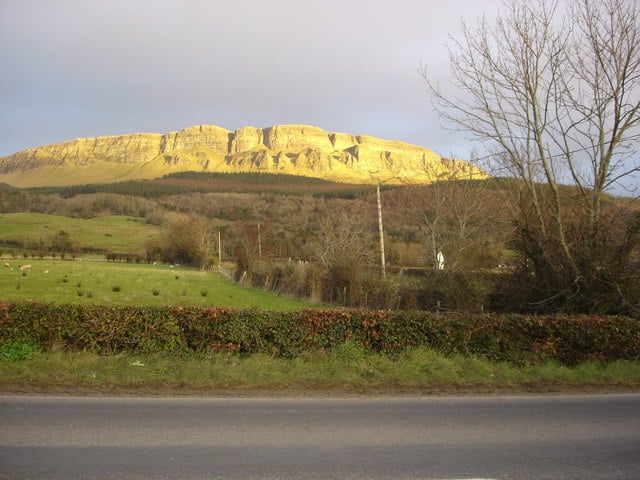 Binevenagh Mountain's golden basalt escarpment catching evening light above the County Londonderry farmland, Northern Ireland