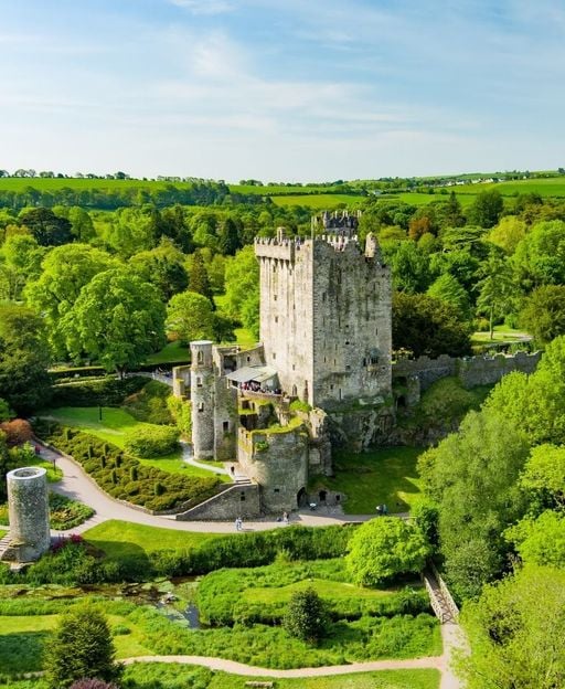 Blarney Castle aerial view surrounded by green gardens, County Cork, Ireland