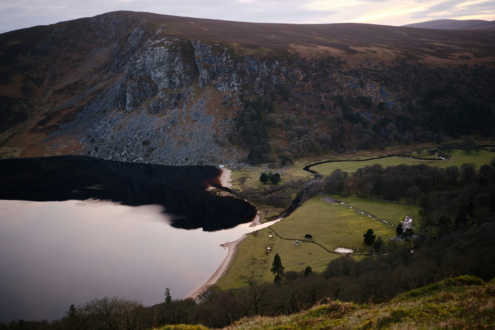 Lough Tay, the Guinness Lake, in the Wicklow Mountains, showing its dark peaty water and pale sandy shore