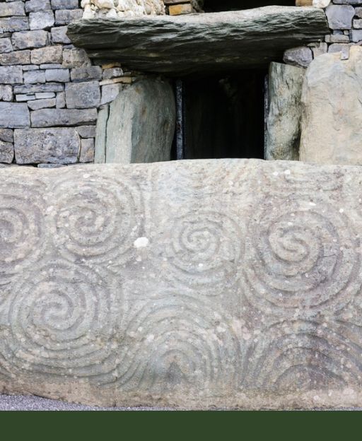Ancient Celtic triple spiral carved in stone at Newgrange passage tomb County Meath Ireland