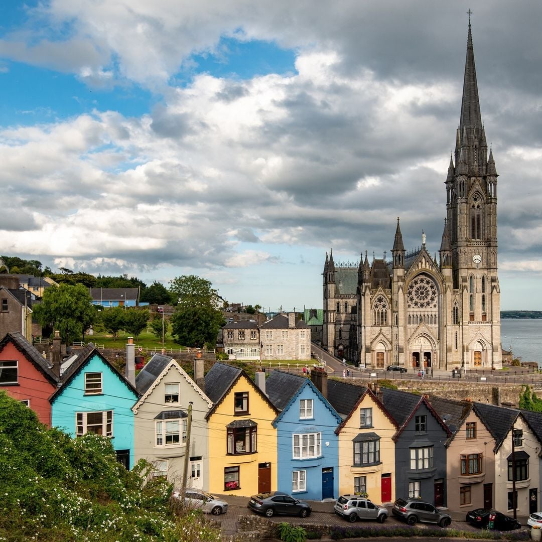 Colourful terraced houses beneath St Colman's Cathedral overlooking the harbour in Cobh, County Cork, Ireland
