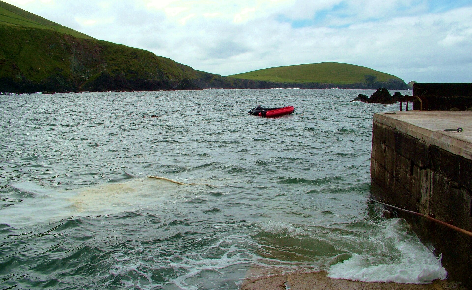 Dunquin Harbour and pier on the Dingle Peninsula, County Kerry, Ireland, looking out towards the Blasket Islands